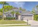 Charming single-story home with lush landscaping, two car garage and freshly cut lawn at 10641 Firebrick Ct, Trinity, FL 34655