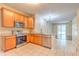 Open-concept kitchen boasts stainless steel appliances and ample counter space at 10641 Firebrick Ct, Trinity, FL 34655
