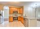 Bright kitchen offers stainless steel appliances, granite countertops, and tiled floors at 10641 Firebrick Ct, Trinity, FL 34655