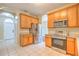 The kitchen features stainless steel appliances, wooden cabinets, and a tile floor at 10641 Firebrick Ct, Trinity, FL 34655