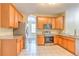 The kitchen features stainless steel appliances, wooden cabinets, and a tile floor at 10641 Firebrick Ct, Trinity, FL 34655