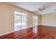 Bright living room featuring hardwood floors, ceiling fan, and sliding glass doors leading to the exterior at 10641 Firebrick Ct, Trinity, FL 34655