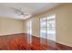 Bright living room featuring hardwood floors and sliding glass doors leading to the exterior at 10641 Firebrick Ct, Trinity, FL 34655
