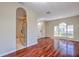 Bright, spacious living room with hardwood floors and natural light from a large window at 10641 Firebrick Ct, Trinity, FL 34655
