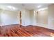 Open-concept living room with hardwood floors and archway access to other rooms at 10641 Firebrick Ct, Trinity, FL 34655
