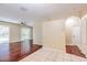 Open-concept living area with hardwood floors leading to sliding glass doors and a screened lanai at 10641 Firebrick Ct, Trinity, FL 34655