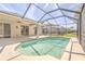 The screened pool offers a private retreat, with tiled trim and a spacious patio for outdoor enjoyment at 10641 Firebrick Ct, Trinity, FL 34655