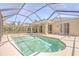 A private screened-in pool offers a relaxing outdoor space, complete with tiled trim and ample patio area at 10641 Firebrick Ct, Trinity, FL 34655