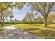 Scenic walking path winding through a lush green space and mature trees within the community at 10641 Firebrick Ct, Trinity, FL 34655