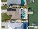 Aerial view of a waterfront home with a swimming pool and boat dock at 11125 7Th E St, Treasure Island, FL 33706