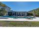 Beautiful backyard with a pool, spa, and white pergola, perfect for outdoor living and entertaining at 11125 7Th E St, Treasure Island, FL 33706