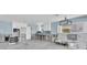 Bright kitchen area featuring white cabinets, a window, and appliances awaiting installation at 11125 7Th E St, Treasure Island, FL 33706