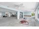Open-concept living area with modern ceiling fan and natural light; under construction after water damage at 11125 7Th E St, Treasure Island, FL 33706