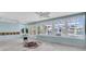 Bright and airy living area with large windows and a view of the pool and waterfront, partially demoed after water damage at 11125 7Th E St, Treasure Island, FL 33706