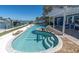 Inviting outdoor pool and spa area with a spacious patio, perfect for relaxation and entertaining at 11125 7Th E St, Treasure Island, FL 33706