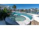 Inviting outdoor pool and jacuzzi area with a view of the water, perfect for relaxation and entertaining at 11125 7Th E St, Treasure Island, FL 33706