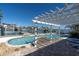 Inviting pool area with clear blue water, a pergola, and view of the waterfront and neighboring docks at 11125 7Th E St, Treasure Island, FL 33706