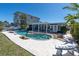 Backyard pool with a patio, lush landscaping, and lounge chairs at 11125 7Th E St, Treasure Island, FL 33706