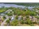 Aerial view of a residential neighborhood with a beautiful lake and lush greenery in the background at 11709 N Armenia Ave, Tampa, FL 33612