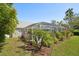 Landscaped backyard featuring a screened-in pool area, perfect for relaxation and enjoying the outdoors at 13553 Landers Dr, Hudson, FL 34667