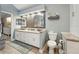 Modern bathroom featuring double vanity, grey tile backsplash, and separate toilet area at 13553 Landers Dr, Hudson, FL 34667