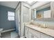 Stylish bathroom featuring granite countertops, white cabinetry, and neutral blue walls at 13553 Landers Dr, Hudson, FL 34667