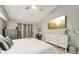 Relaxing bedroom with neutral walls, a ceiling fan, and an entertainment center at 13553 Landers Dr, Hudson, FL 34667