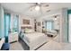 Comfortable bedroom with ample natural light, featuring a large mirror closet and ceiling fan at 13553 Landers Dr, Hudson, FL 34667