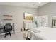 Bedroom with desk, shelves, and door to en suite bathroom at 13553 Landers Dr, Hudson, FL 34667