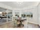 Bright breakfast nook with backyard view, featuring a round table and tile flooring at 13553 Landers Dr, Hudson, FL 34667