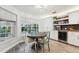 Bright dining area with round table, backyard view, and modern lighting at 13553 Landers Dr, Hudson, FL 34667