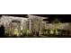 Charming home exterior featuring decorative stone, arched entry and lush landscaping with exterior night lighting at 13553 Landers Dr, Hudson, FL 34667