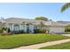 Well maintained one-story home with lush green lawn, manicured landscaping, and inviting front entrance at 13553 Landers Dr, Hudson, FL 34667