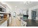 Spacious kitchen featuring wood-look tile flooring and modern white cabinetry with stainless steel appliances at 13553 Landers Dr, Hudson, FL 34667