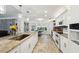 Bright, airy kitchen featuring granite counters, pendant lights, and stainless steel appliances, plus backyard view at 13553 Landers Dr, Hudson, FL 34667