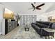 Spacious living room featuring a large television and view to a modern kitchen at 13553 Landers Dr, Hudson, FL 34667