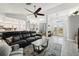 Open-concept living room with modern furnishings, a ceiling fan, and an entryway view at 13553 Landers Dr, Hudson, FL 34667