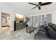 Cozy living room featuring an entertainment center, modern furnishings, and a ceiling fan at 13553 Landers Dr, Hudson, FL 34667