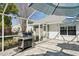 Outdoor patio with built-in grill, pavers, and view of the backyard at 13553 Landers Dr, Hudson, FL 34667