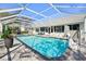 Refreshing swimming pool with a slide, deck chairs, umbrella and grill for perfect Gathering fun at 13553 Landers Dr, Hudson, FL 34667