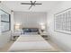 Stylish bedroom with modern lighting, accent wall panels, and large window at 14233 Eagle Branch Dr, Nokomis, FL 34275