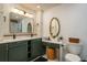 Bathroom featuring double sink vanity with sleek countertops and modern fixtures at 1732 Hickory Gate N Dr, Dunedin, FL 34698