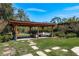 Relaxing backyard pergola featuring lounge seating and adjacent grill at 1732 Hickory Gate N Dr, Dunedin, FL 34698