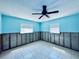 Bedroom with blue walls, windows, ceiling fan and ceramic tile flooring at 1800 New Hampshire Ne Ave, St Petersburg, FL 33703