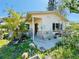 Charming single-story home showcasing a quaint front porch with stone accents and mature landscaping in need of some TLC at 1800 New Hampshire Ne Ave, St Petersburg, FL 33703