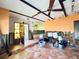 Open-concept living room with unique tile flooring and a partial renovation that exposes some of the wall framing at 1800 New Hampshire Ne Ave, St Petersburg, FL 33703