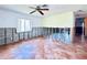 Spacious living room with red tile flooring, ceiling fan, and view of the window at 1800 New Hampshire Ne Ave, St Petersburg, FL 33703