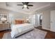 Bright bedroom featuring a tray ceiling, ceiling fan, and a walk-in closet for ample storage at 1805 W Norfolk St, Tampa, FL 33604