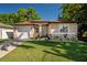 Charming single-story home featuring manicured lawn, well-kept landscaping, and an attached one-car garage at 1805 W Norfolk St, Tampa, FL 33604