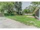 An expansive yard with lush greenery and mature trees, enclosed by a wood fence at 1807 23Rd N Ave, St Petersburg, FL 33713